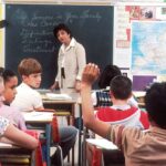 Children in a Classroom. In the back of a classroom, are children about 11 years old with a female teacher talking about the subject - If Someone in Your Family Has Cancer. Photographer Michael Anderson