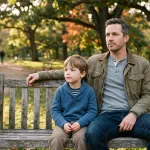 Adult and child sitting thoughtfully on a park bench